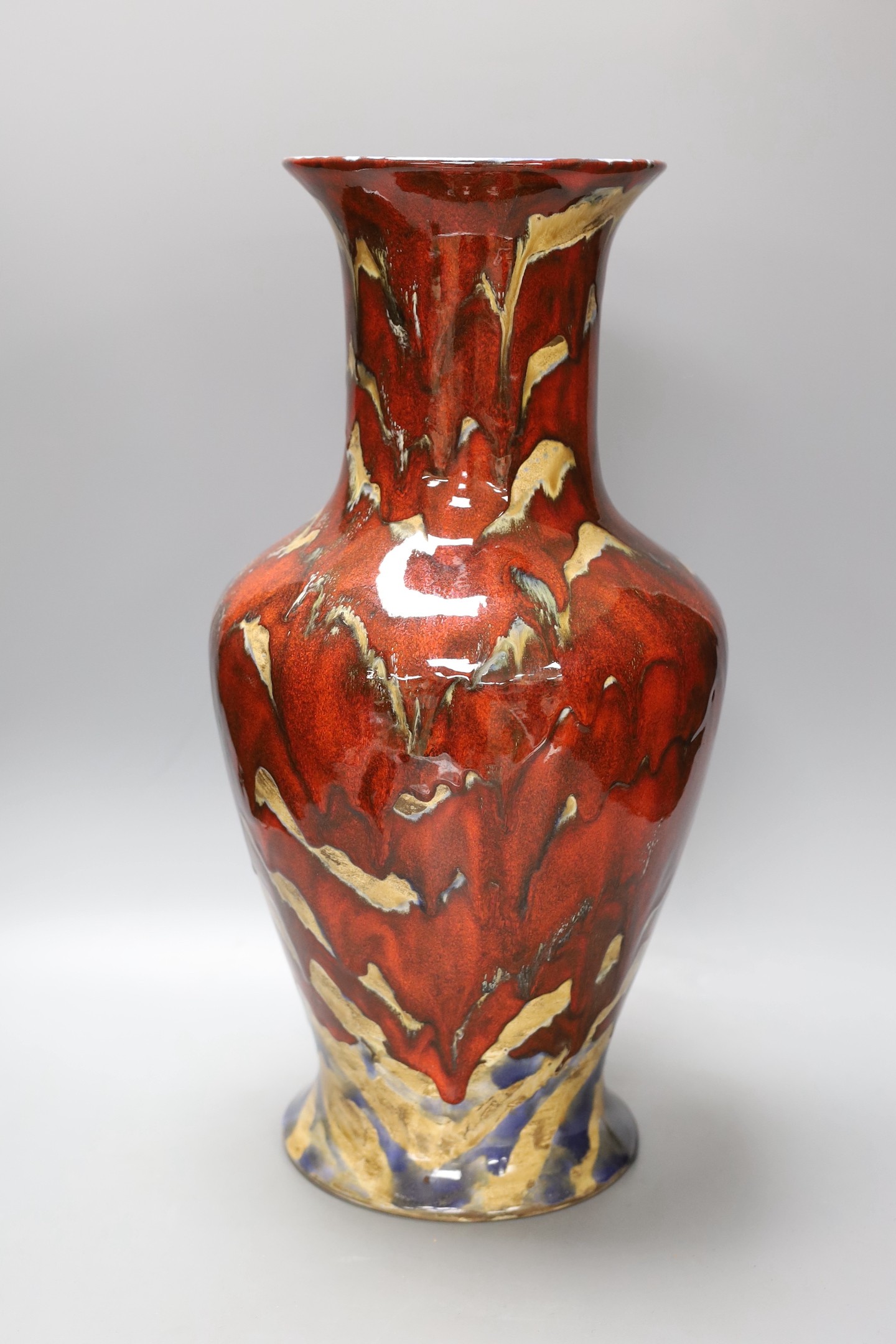 A large black Ryden pottery red glazed vase 47cm